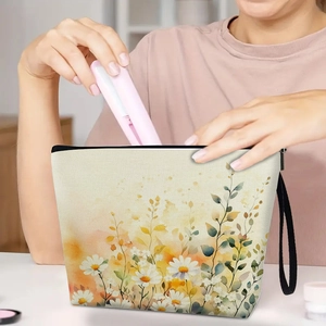 Floral watercolor toiletry bag with daisy pattern and wristlet strap for organization