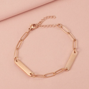 Detail of rose gold paperclip chain bracelet with adjustable lobster clasp and blank bar