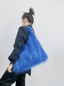 Blue faux fur shoulder tote bag with a fluffy texture shown on model back view