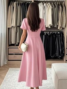 Rear view of pink A-line midi dress with zipper back and short sleeves in a walk-in closet