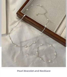 Close-up of S925 silver wavy jewelry set with freshwater pearls on elegant display