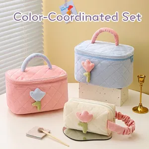 Quilted corduroy cosmetic bag set with tulip embroidery in pink, blue, and white colors