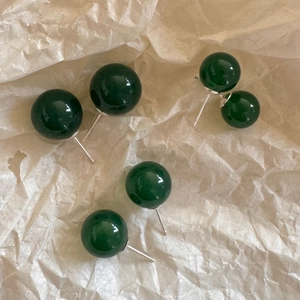 Deep green agate stud earrings with 925 sterling silver needles on craft paper