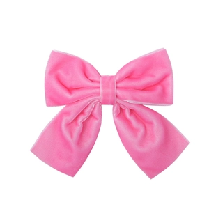 Detail of pink velvet handmade hair bow clip with soft texture for girls