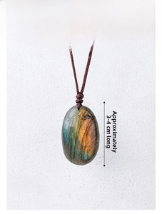 Detailed close-up of natural labradorite pendant with blue flash and braided cord