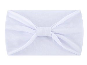 Detailed view of a soft white knotted headband with smooth fabric texture on white background