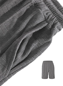 Detail of grey men's waffle knit shorts with drawstring elastic waist and fabric texture