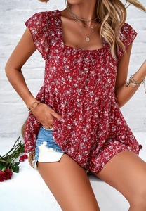 Detail of red floral square neck blouse with ruffle sleeves and pleated smocked texture