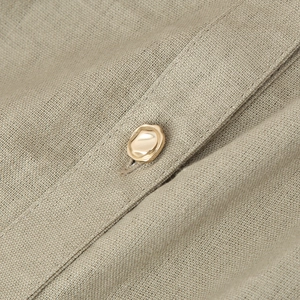 Linen blend sleeveless dress with elegant V-neck and decorative golden metal button