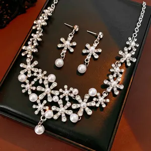 Elegant floral jewelry set featuring pearl and diamond necklace with matching earrings