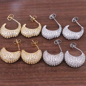Elegant C-shaped crescent stud earrings in gold and silver with sparkling pave-set stones