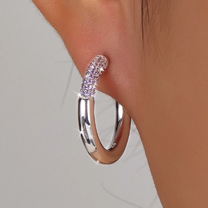 Close-up of S925 sterling silver hoop earrings with purple zircon inlay on a model