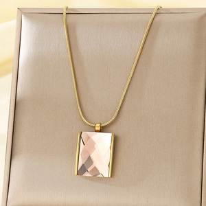 Close-up of champagne rectangle glass pendant on gold stainless steel snake chain