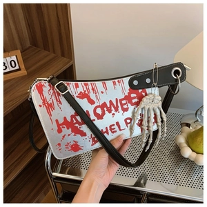 Close-up of clever meat cleaver bag with bloody Halloween text and skeletal hand charm