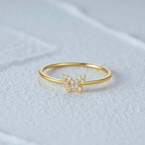 Macro view of a gold-plated butterfly ring featuring sparkling zircon inlay accents