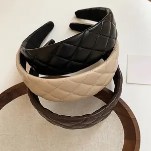 Quilted leather headbands in black, beige, and brown with a classic diamond pattern