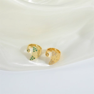Vintage gold adjustable rings with hammered texture and set with green and white gemstones