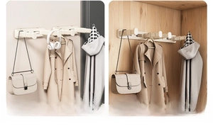 Detail showing wall-mounted cream retractable hooks for coats and home organization