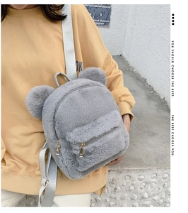 Gray plush backpack with cute 3D bear ears and adjustable straps shown on model
