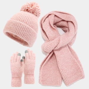 Close-up of knit winter set with soft pom-poms, thick scarf, and touch-screen gloves in pink