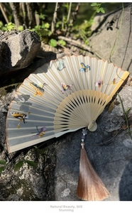 Exquisite hand-stitched butterfly embroidery on a semi-sheer silk folding fan with silk tassels