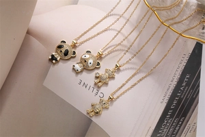 Detail of gold necklaces with micro-pave zircon panda and teddy bear pendants