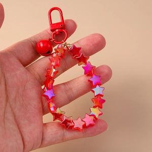 Cute red star beaded keychain with metal bell and lobster clasp shown on a plain background