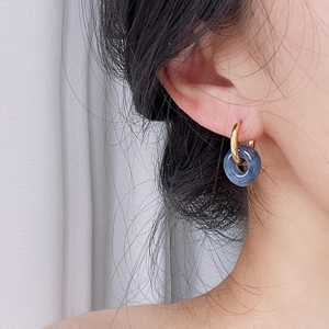 18k gold plated stainless steel hoops with blue marble stone donuts on female model