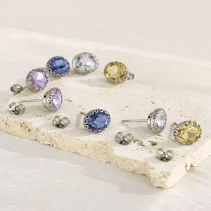 Elegant multi-colored oval rhinestone stud earrings with filigree lace setting on stone