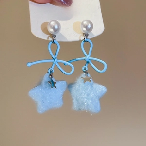 Close-up of blue wire bow earrings with fuzzy star pendant and white faux pearl stud