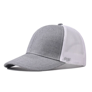 Detail of grey trucker hat featuring breathable white mesh and durable curved brim stitch