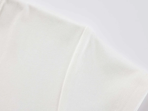 Close-up of seamless stitching and premium cotton knit texture on a white modal t-shirt