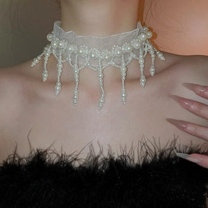 Detailed view of lace mesh choker with elegant white pearl tassels on a model
