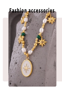 Detailed shot of freshwater pearl necklace with green bead and star charm pendant