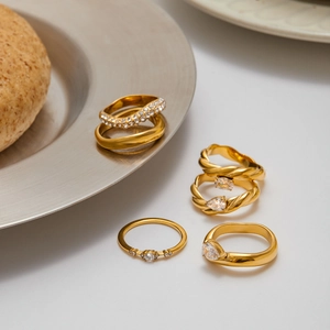 Luxurious gold stainless steel ring set with sparkling white zircon in social setting