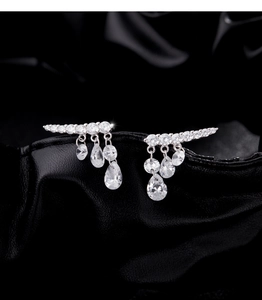 Macro shot of S925 sterling silver tassel earrings with shimmering pear-cut water drop charms
