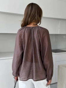 French V-neck brown lantern sleeve blouse with ruffle detailing and pleated back view