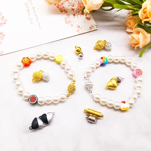Detail of gold magnetic jewelry clasps with pearl bracelets and colorful PVC charms