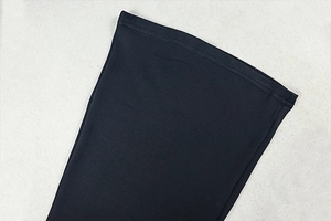 Close-up of high-density knit fabric and fine stitching on the black jumpsuit cuff