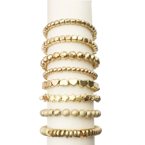 Gold multi-layer elastic bracelet set featuring square, heart, and star-shaped CCB beads