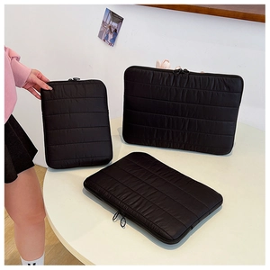 Detailed view of three quilted black laptop sleeves with zipper in different sizes