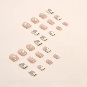 Short square press-on nails with abstract blue, pink, and yellow smiley patterns