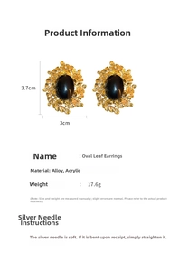 Macro view of vintage gold leaf earrings with oval black stones and sizing specifications