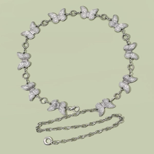 Detail of silver butterfly link chain belt with lobster clasp and adjustable metal ring