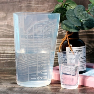 Close-up of translucent silicone measuring cups with clear 500ml and 50ml scale markings