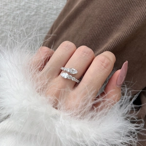 Detail shot of a silver vine snake ring with sparkling zircons worn by a model