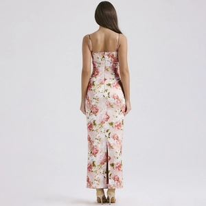Detail of the back view of a pink floral maxi dress featuring a high slit and thin straps