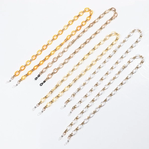 Bohemian acrylic eyeglass chains in orange and amber colors for women on white backdrop