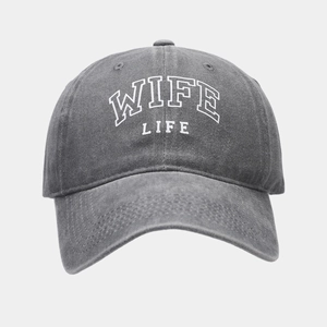 Close-up of WIFE LIFE white embroidery on washed dark grey vintage baseball cap