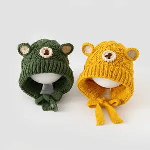 Kids knitted bear hat with ears and chin ties in green and yellow for winter warmth